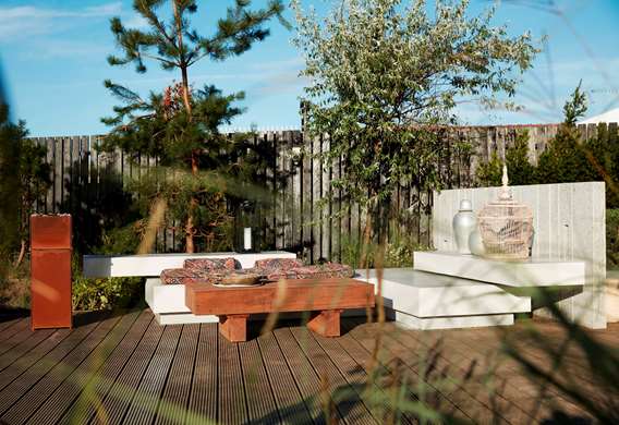 Træterrasse med loungemiljø og gasbål tegnet af havearkitekt Tor Haddeland